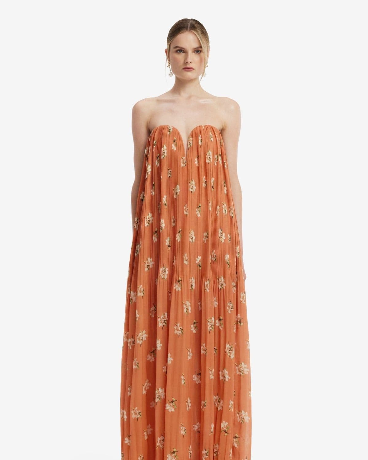 Model wearing the Dahlia Gown in Lily Print (Ochre), full-length dress product/lifestyle shot