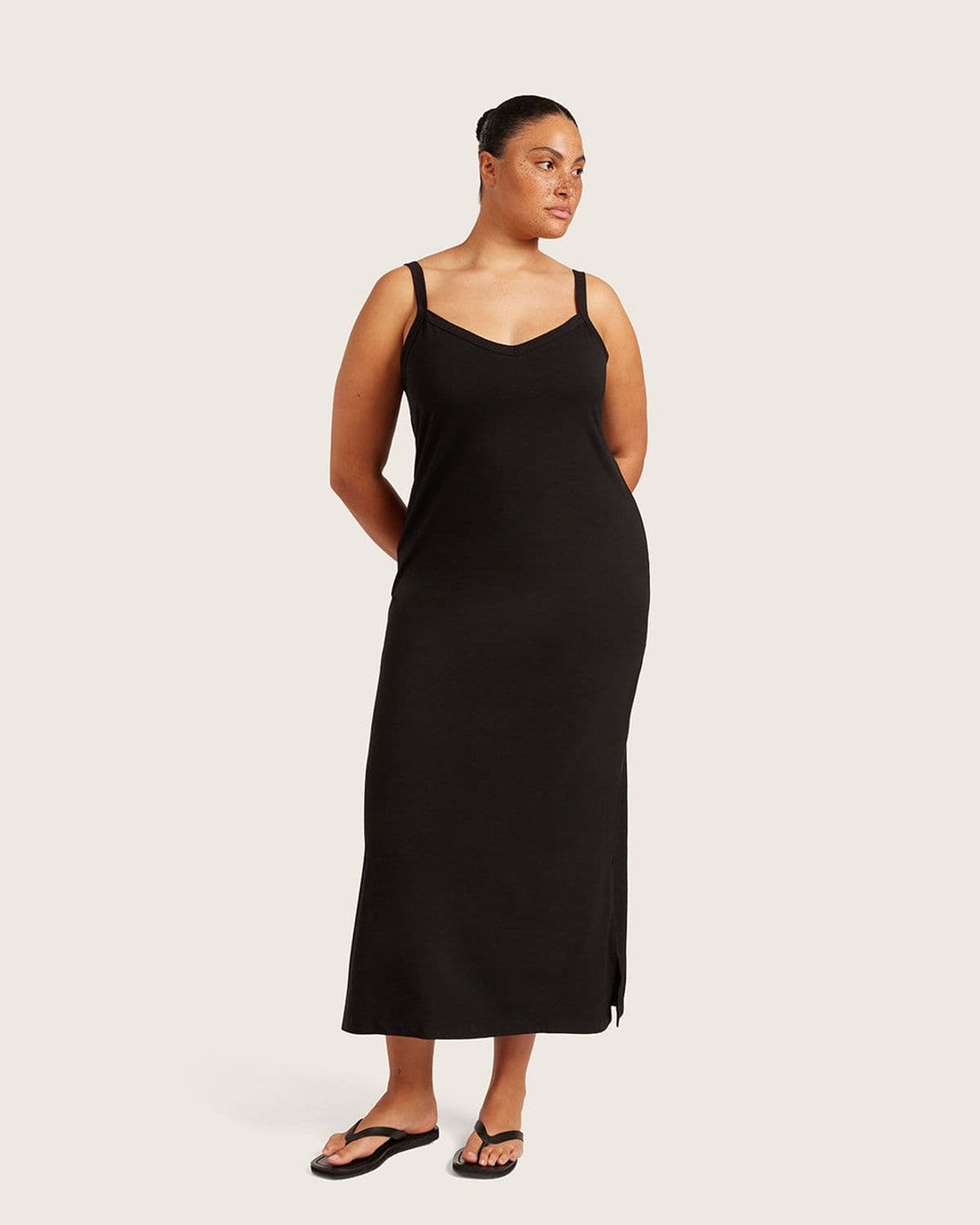 Model wearing Boody's black V-Neck Slip Dress, primary on-model product shot