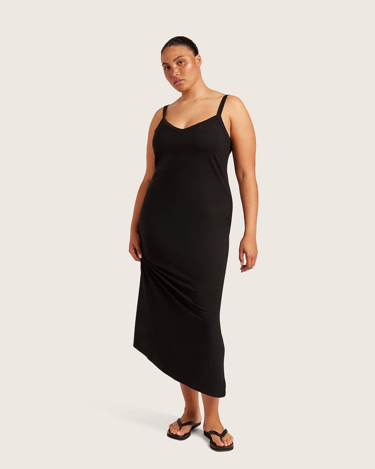 Additional lifestyle shot of a model styled in Boody's black V-Neck Slip Dress