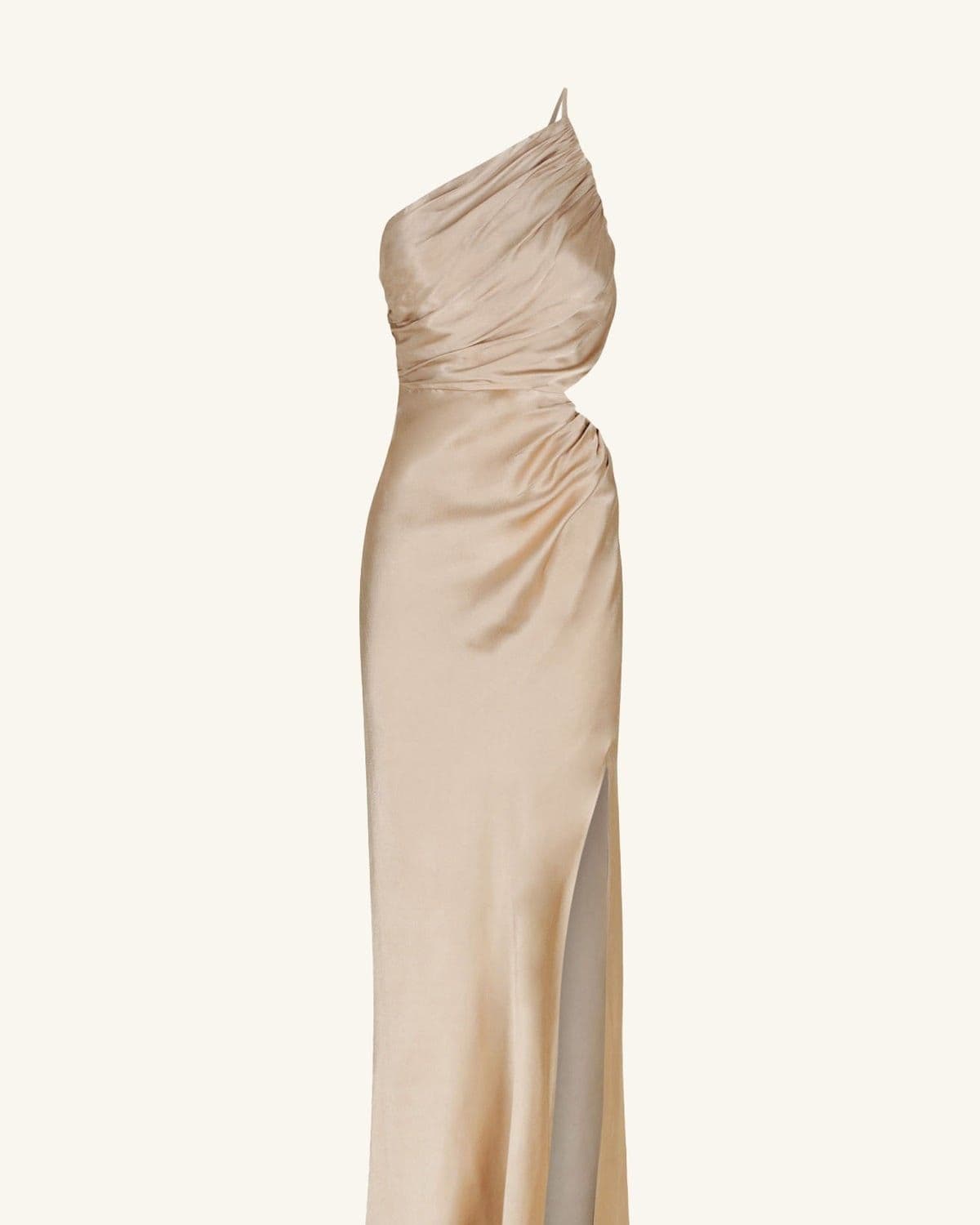 Model in the same gold asymmetrical gathered maxi dress, side-profile studio shot showing the thigh-high slit