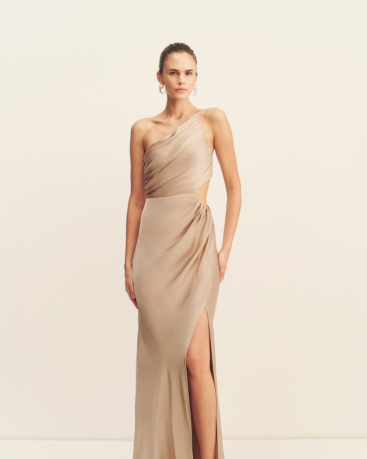 Model in the La Lune Asymmetrical Gathered Maxi Dress (gold), front-facing studio shot, one-shoulder ruched satin gown with cutout waist